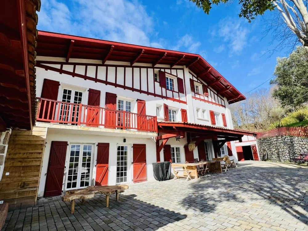 Traditional stone farmhouse in the Gascon countryside with wooden beams and tiled roof