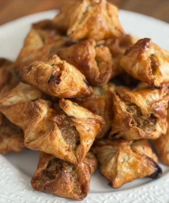 Golden puff pastries filled with duck confit and pear